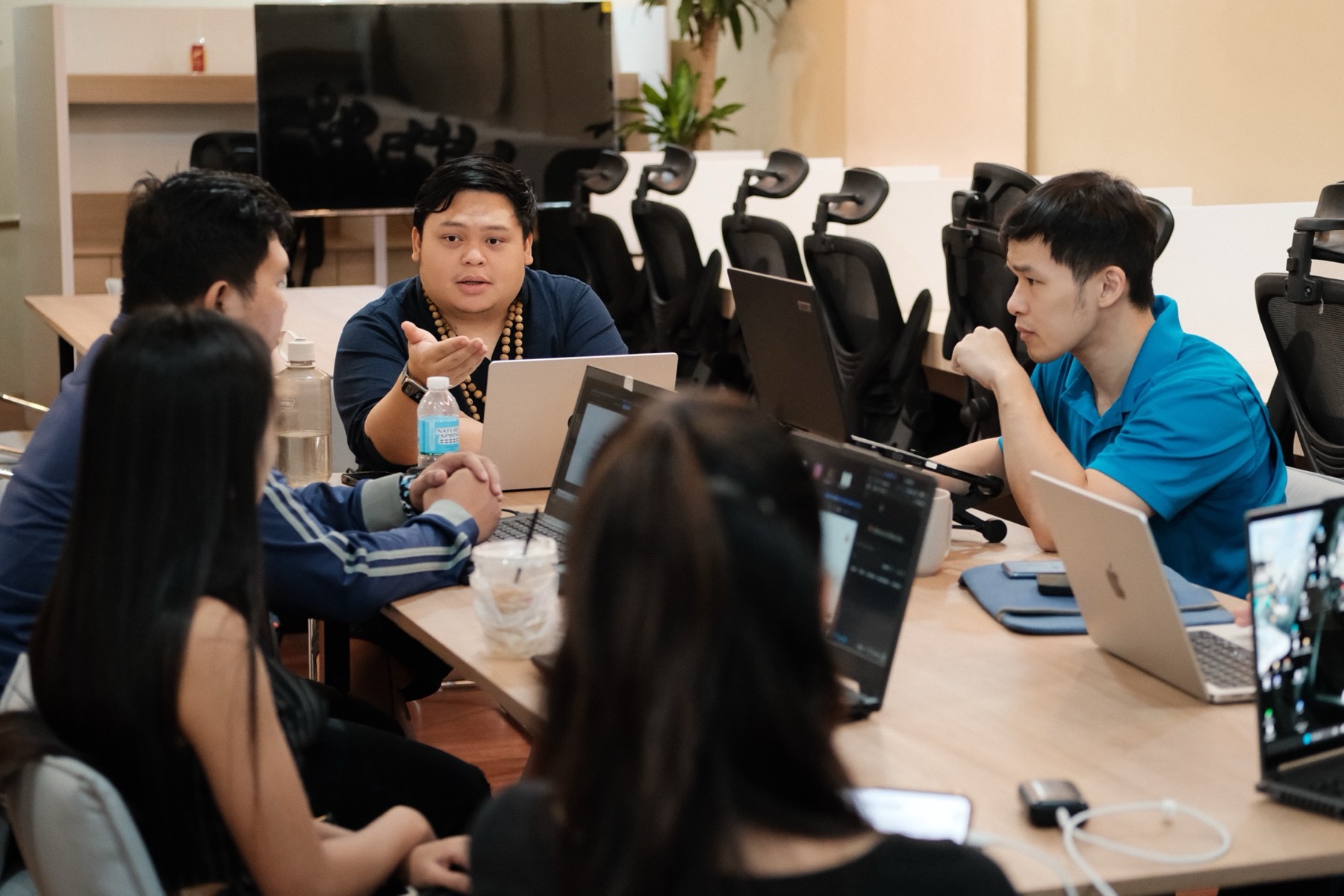 Builders huddled over laptops during a live session